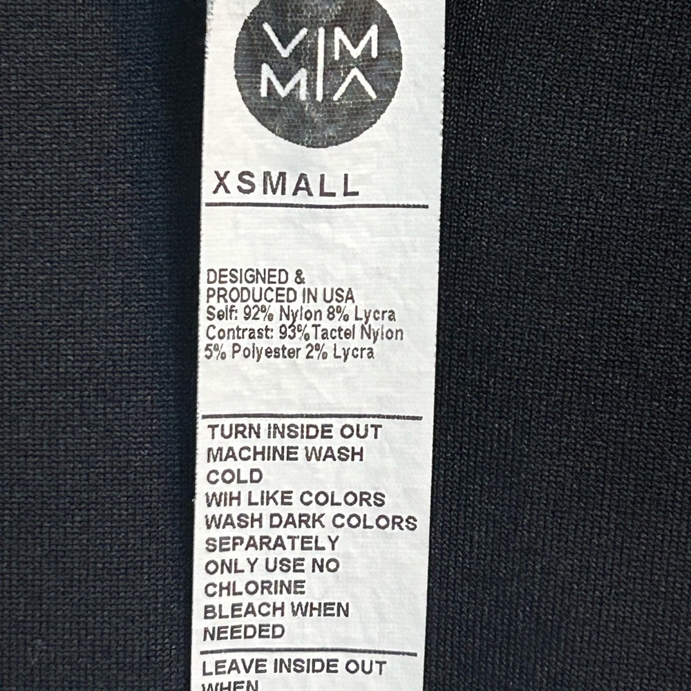 Athletic black tight fitting shirt with thumb holes on each sleeve.